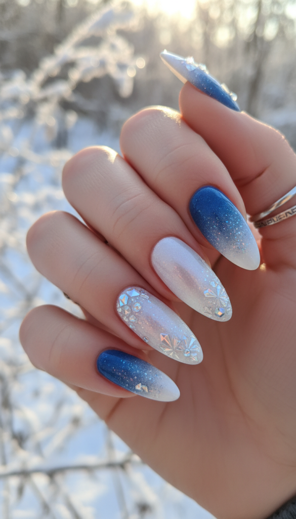 A close-up view of a beautifully manicured hand showcasing crystalline frost nail art on long, elegant nails. The design features a gradient from icy blue to shimmering white, with intricate crystalline patterns resembling frostflakes delicately scattered across a glossy French tip. The foreground highlights the brilliance of the nail art, with soft glimmers and reflections catching the light. The middle features a light, frosted background that evokes a winter theme, subtly illuminated by soft, diffused natural light, creating an ethereal atmosphere. The image is shot at a slight angle to emphasize the nail details while maintaining a clean and polished aesthetic. The mood is serene and enchanting, perfect for winter fashion.